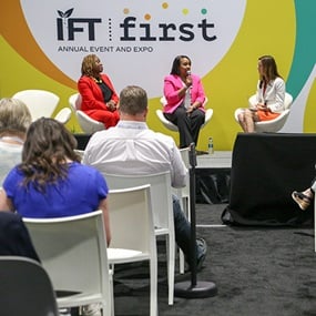 IFT FIRST panel speakers on stage in front of an audience