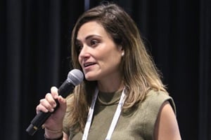 Winner Helaina speaking into a microphone on stage during The Pitch Finale.