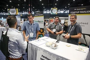 IFT FIRST Startup Pavilion booth with attendee talking to the exhibitors
