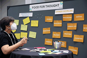 IFT FIRST attendee looking at a Food for Thought board with card display