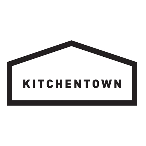 Kitchentown logo with text inside a pentagon shape in black.